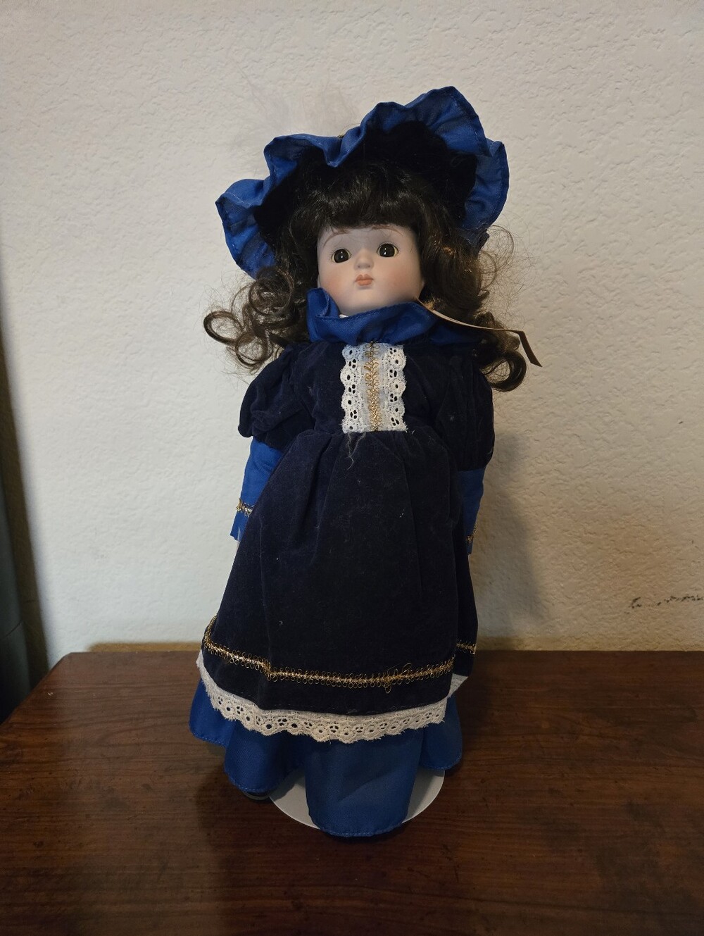 Vintage-Style Porcelain Doll in Dark Blue Dress and Bonnet